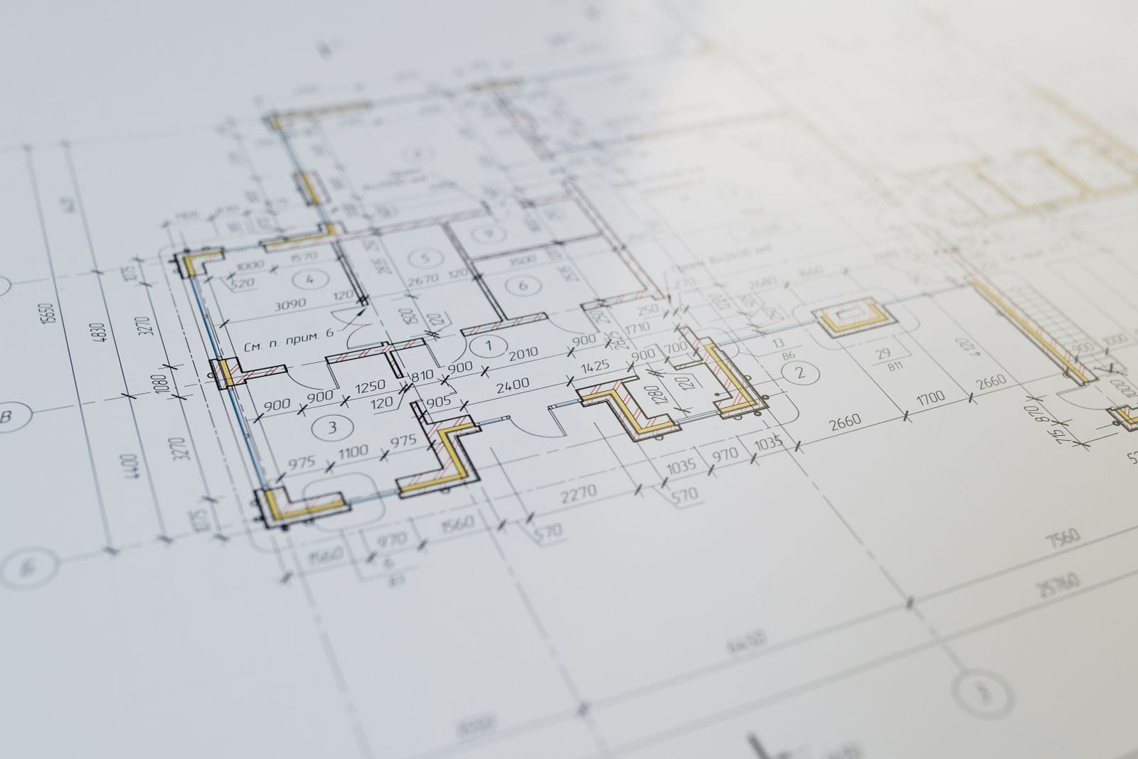 Architectural floor plan drawing on a desk